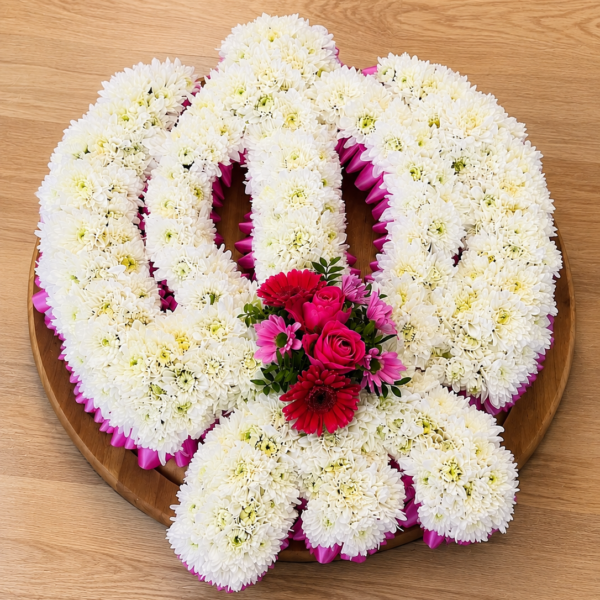 Funeral tribute in Grays, Thurrock with red roses and seasonal flowers